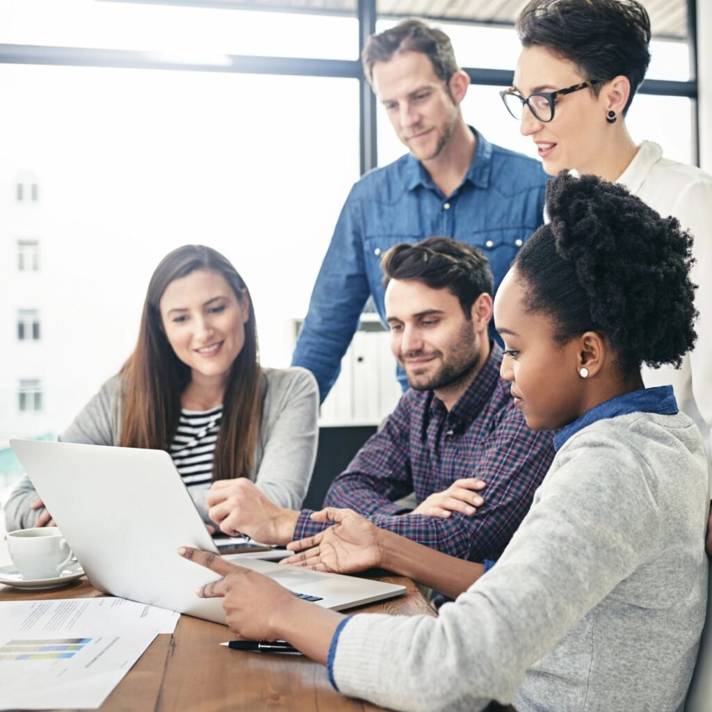 People collaborating around a laptop